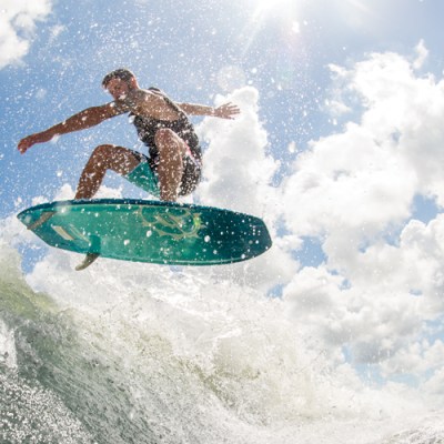 a man riding a wave on a surfboard in the water