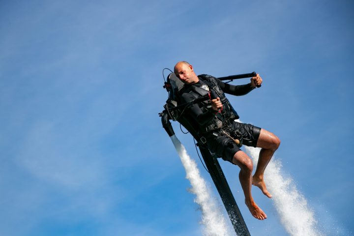 a person riding a surf board in the air