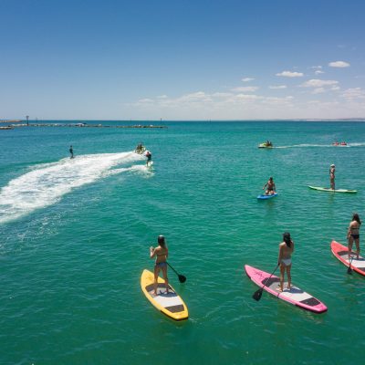 a group of people surfing in the ocean