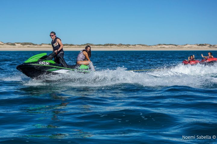 a girl riding a wave on a surfboard in the water