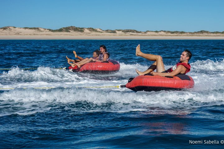 a man riding a surfboard on top of a body of water