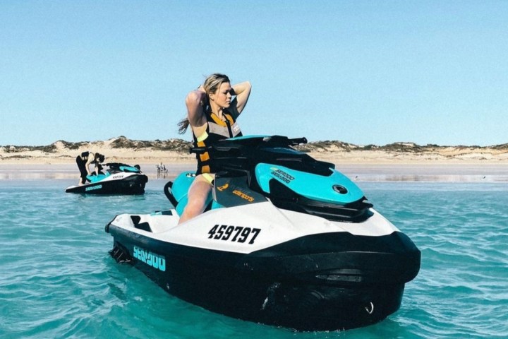 a person riding on the back of a boat in the water