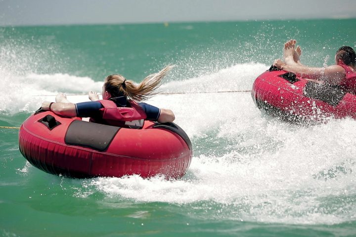 a girl riding a wave on a surfboard in the water