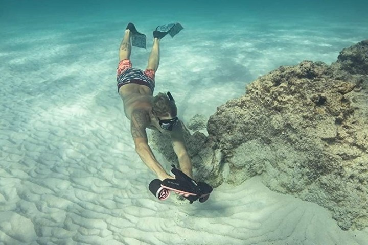 a person riding a skate board in the water