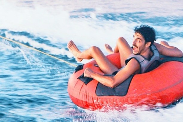 a person riding a surf board on a body of water