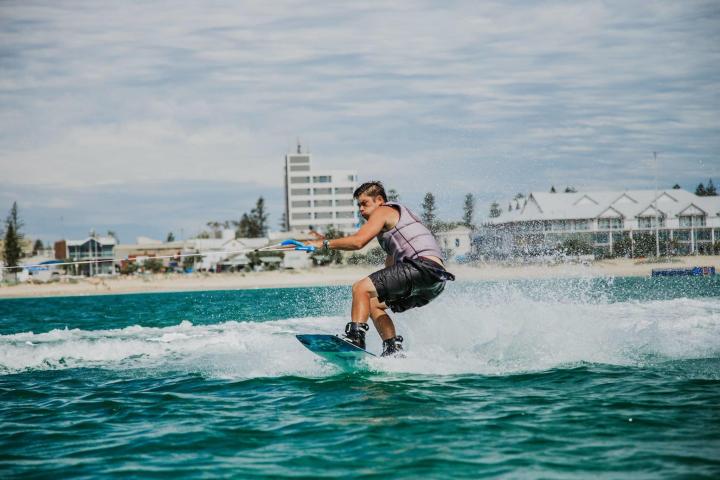 a man riding a wave on top of a body of water
