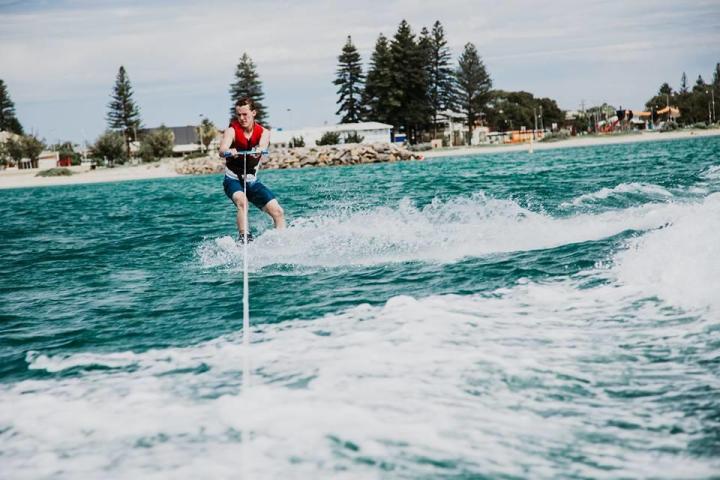 a person riding a surf board on a body of water